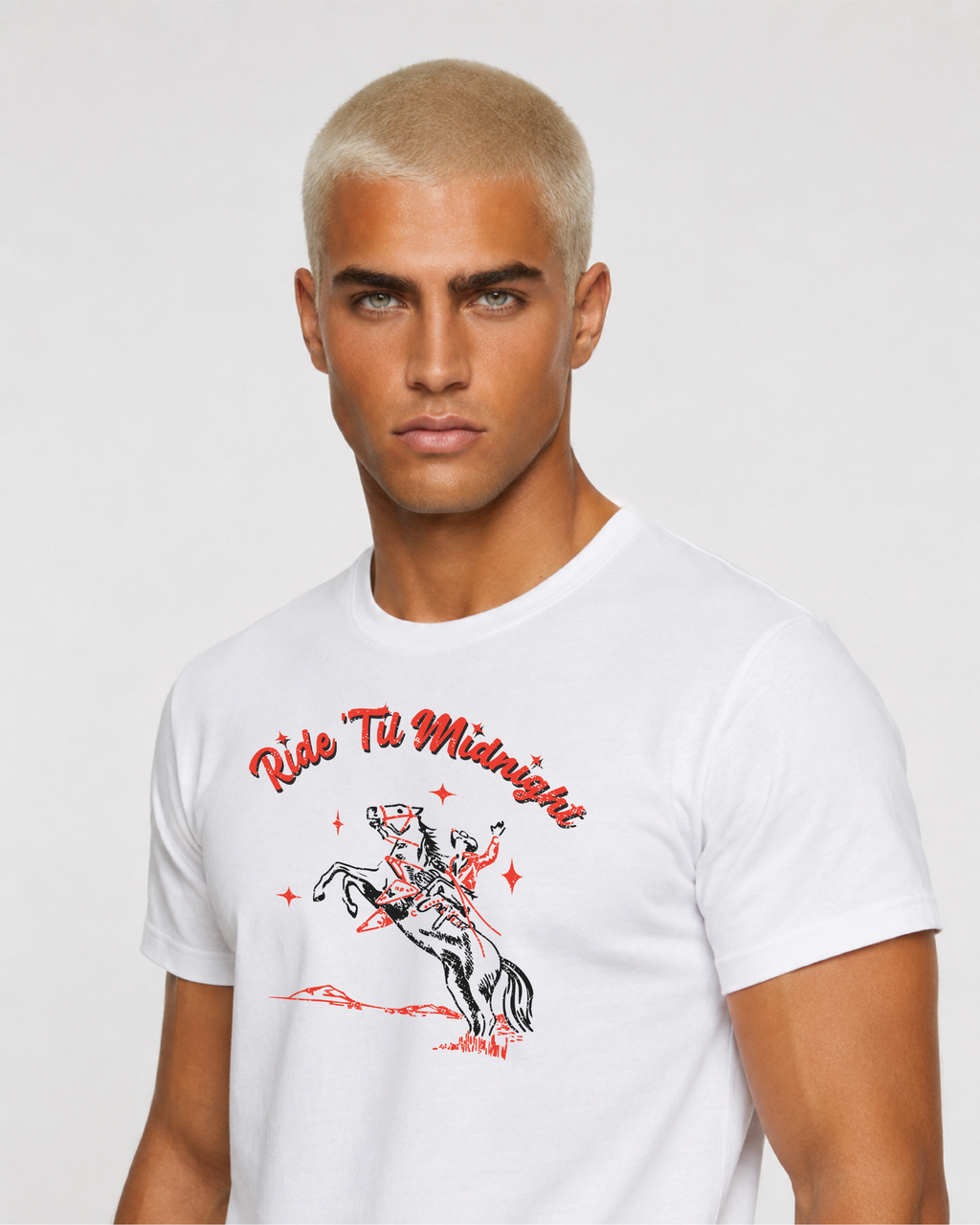Close-up of male model wearing the white "Ride 'Til Midnight" western cowboy graphic t-shirt, chest and face detail shot